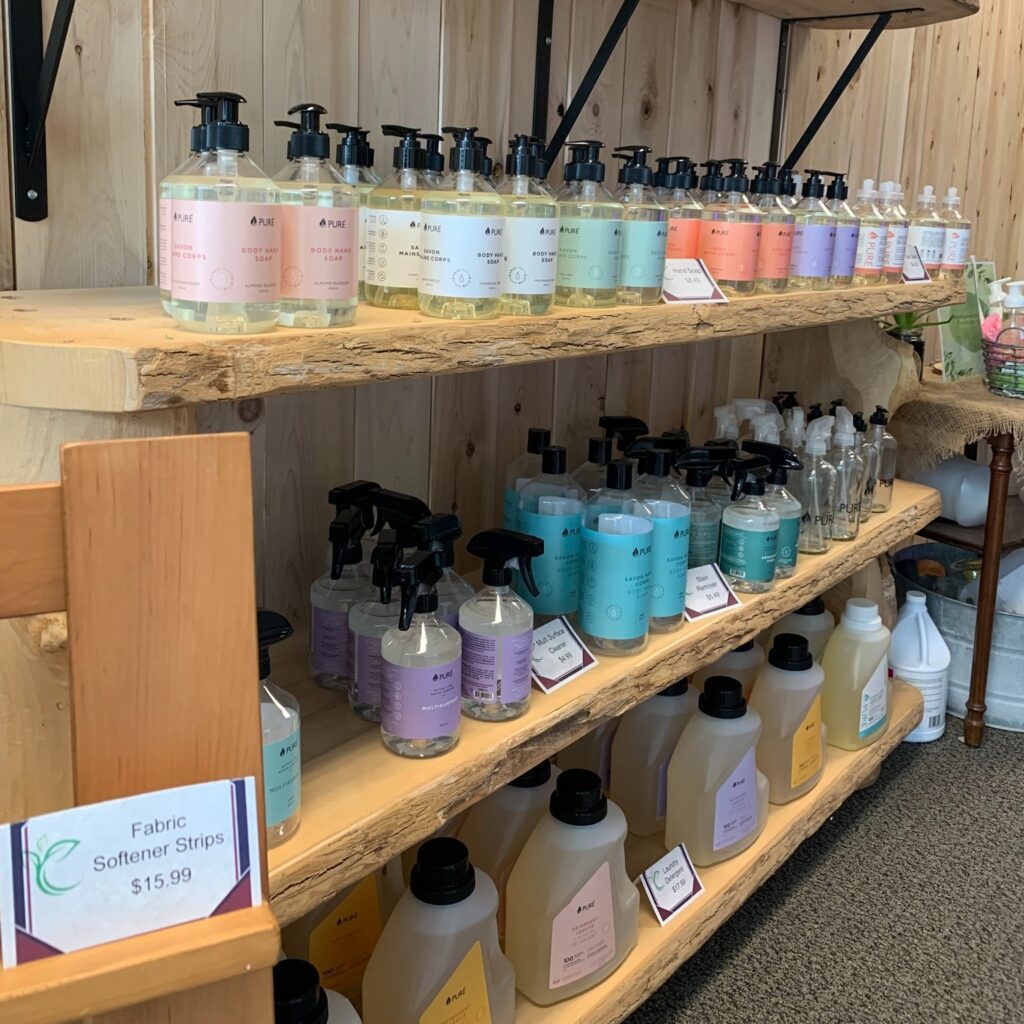 Shelves stocked with refillable soaps, cleaners, and personal care products at the Refill Station.