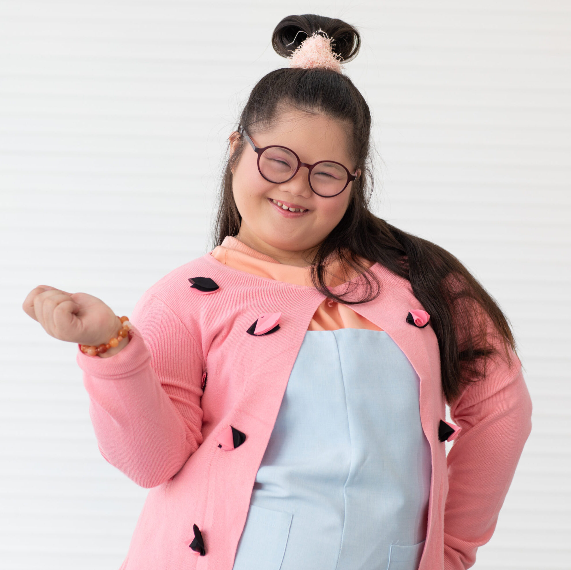 Portrait of beaufiful and cute teen Asian down syndrome girl posing as a model with fun and delight self-confidence.